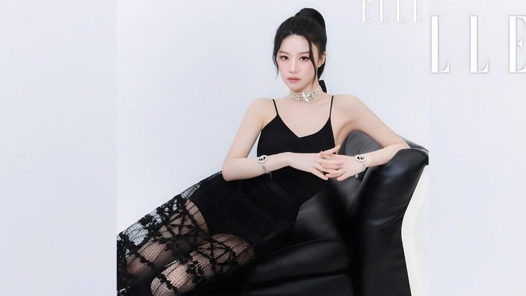 Go Hyun Jung lounges on a black leather couch in a black dress with lace overlay, choker, and bracelets, hands clasped.