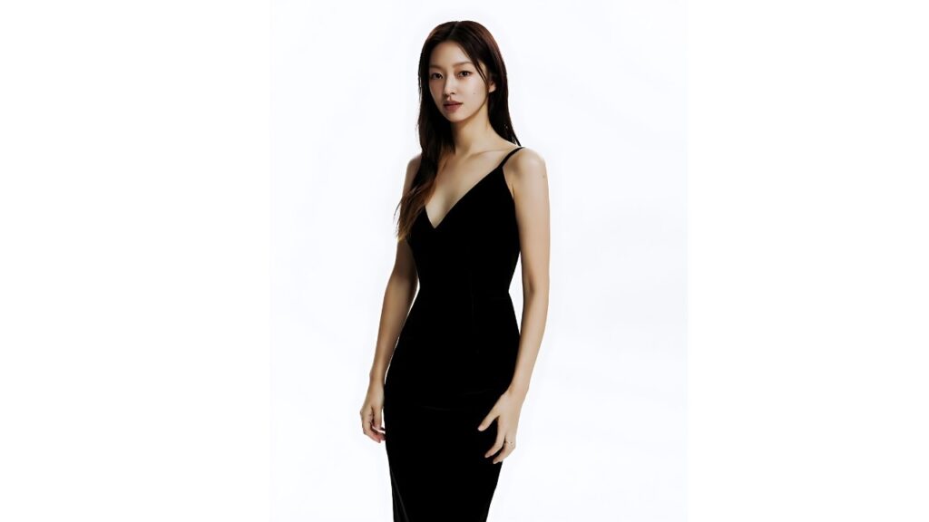 Cha Hyun-jung (차현정) in a sleek black spaghetti-strap dress stands against a white studio backdrop, gazing softly at the camera.
