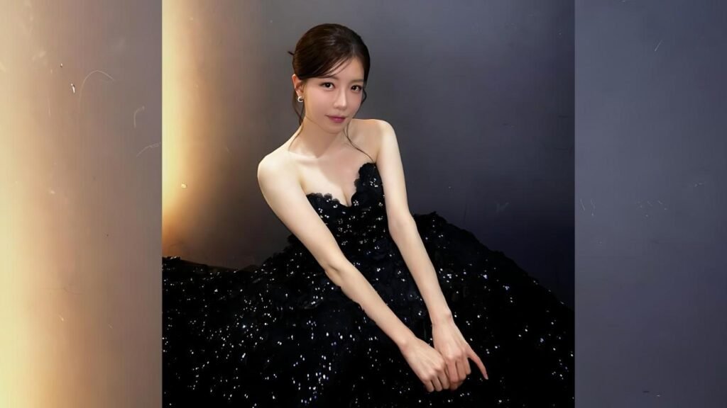 Jung In-sun in a voluminous black sequin strapless gown sits against a dark backdrop, hands folded gracefully in front.