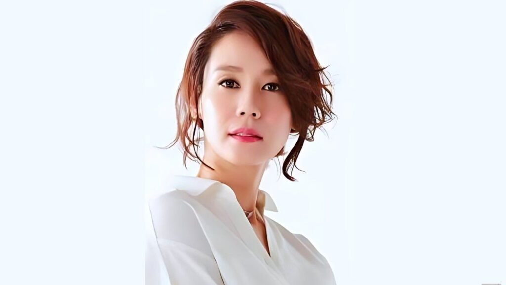 Kim Ji-ho (김지호) with short brown hair in a white blouse, gazing softly at the camera with a gentle smile.