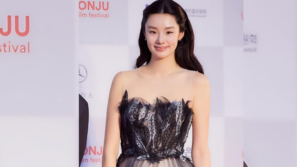 Stephanie Lee on red carpet in a black sheer lace gown with delicate straps and feathered details at ONJU Film Festival.
